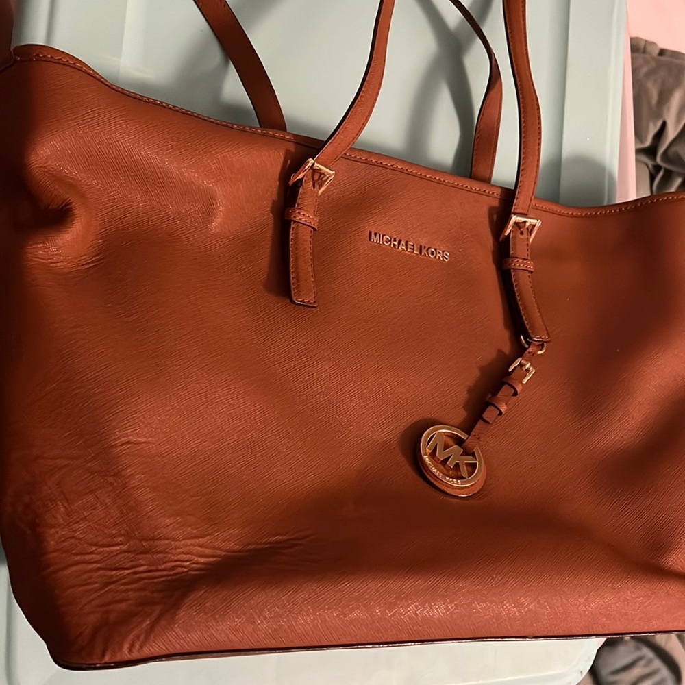 Brown Michael Kors shoulder purse with matching wallet.